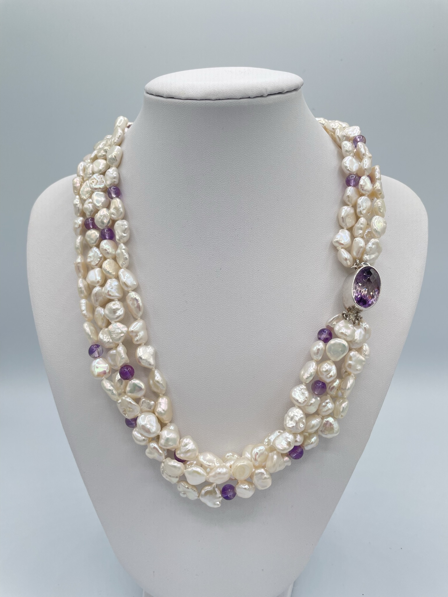 https://nantucketpearlcompany.com/2018/wp-content/uploads/2023/04/N2363-Triple-strand-keshi-pearls-6.5-round-amethyst-Amethyst-stone-and-sterling-clasp-20-in-250.jpg